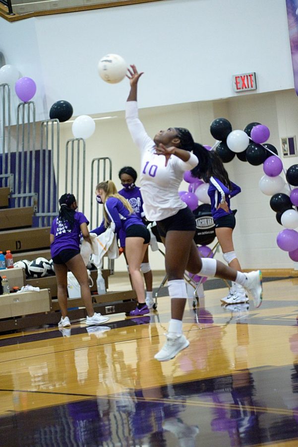 Senior Raven Edwards jumps for the ball during the match on Senior Night.