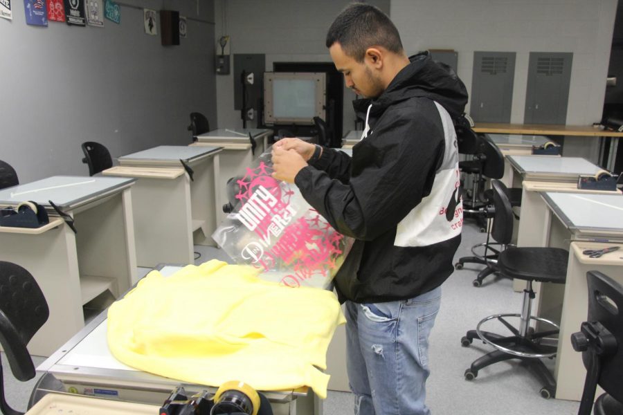 Nathan Salazar Mota works on his signature T-shirts in the Print Shop.