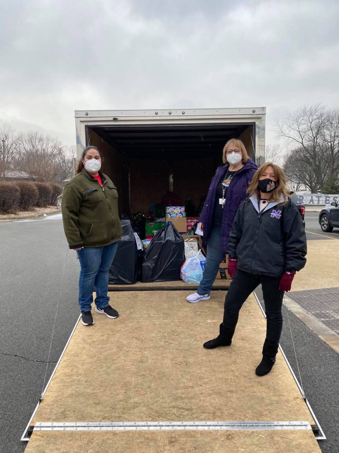 Student Government Co[sponsors Ms. Lena Kiser, Mrs. Sheryl Loving and Ms. Cheryl Austin begin packing gifts in a truck to take to an elementary school.