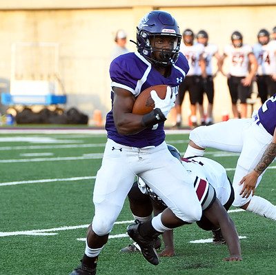 Senior running back Lavarion Logan breaks a tackle against Andrean. Logan ran for four touchdowns in that game. 