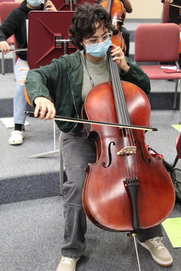 Senior Noelia Arichivala plays the cello in orchestra class a year after undergoing a procedure on her heart.