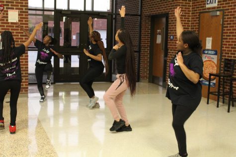 Junior Journey Pleasant. foreground,  follows a move during a step team practice.