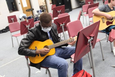 Senior EliJah Bynum practices a song during a recent guitar class.