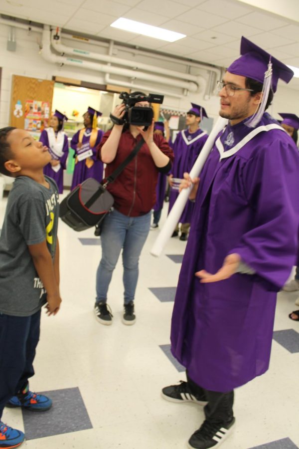 Valedictorian Vincent Feliciano visits with students at Iddings Elementary last week.