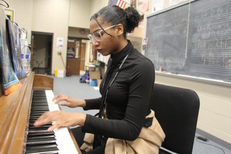 Freshman Eliza Cheatham practices the piano in the orchestra room during her lunch hour. 