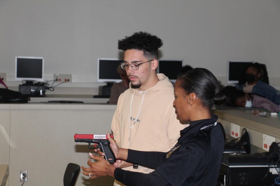 Ms. Torey Dabney-Houseworth works with a student during a simulation in Criminal Justice class. 