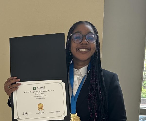 ORiya Gibson proudly displays the award she won at a recent competition for health-care students.
