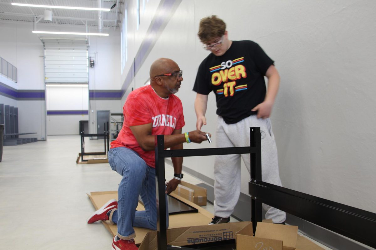 Mr. Taylor and his student build cabinets for the new CTE space.