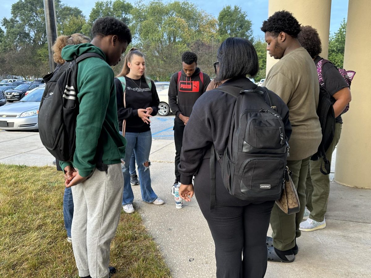 Junior Brianna Koves leads students in prayer ta the annual See You at the Pole event.