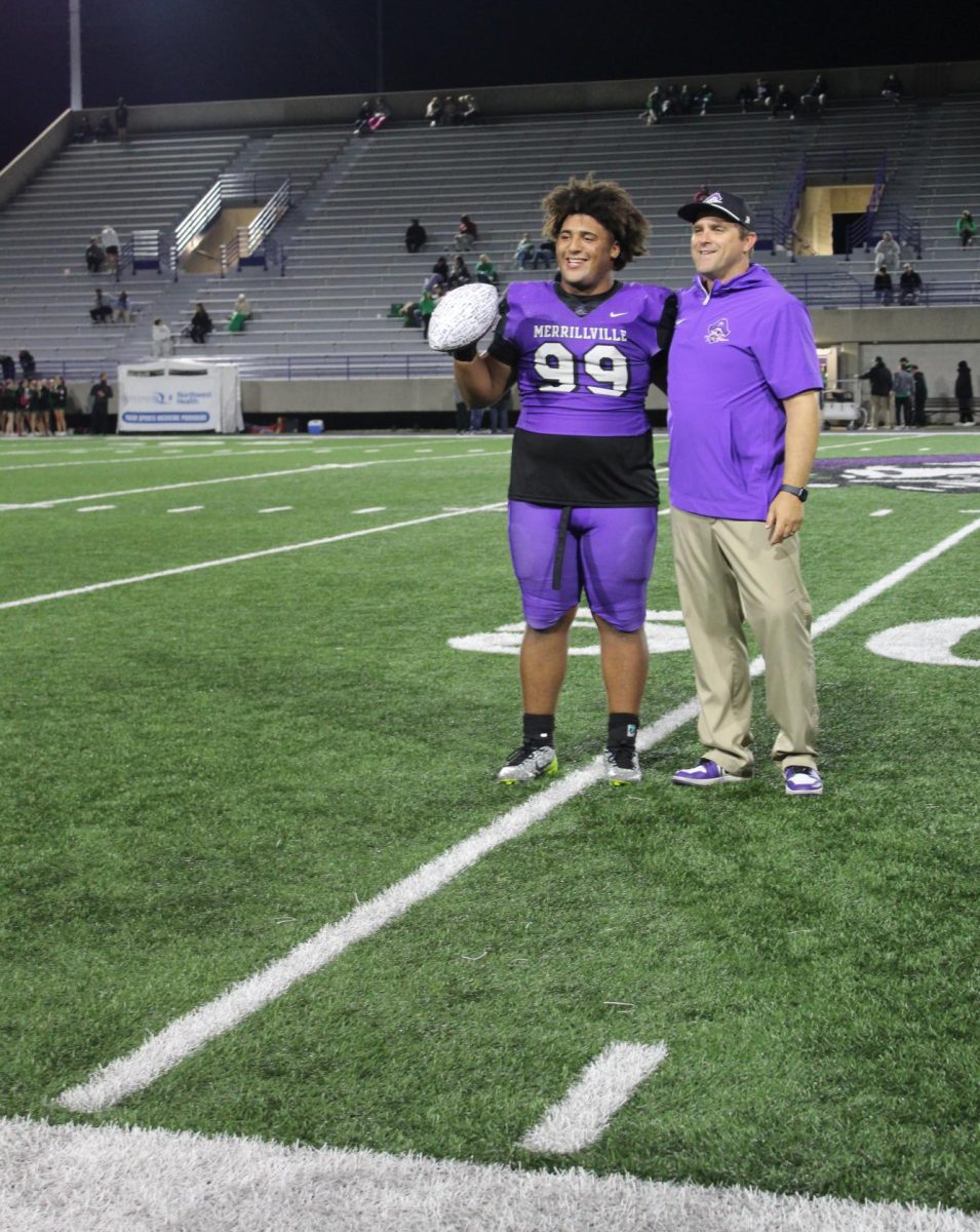 Adam Camphor, shown with Coach Brad Seiss, receives the Mr. Football award.