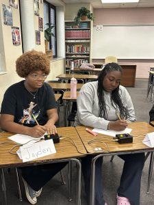 Jayden Valliant listens to a question with Quiz Bowl teammate Chloe Smith during a recent competition.