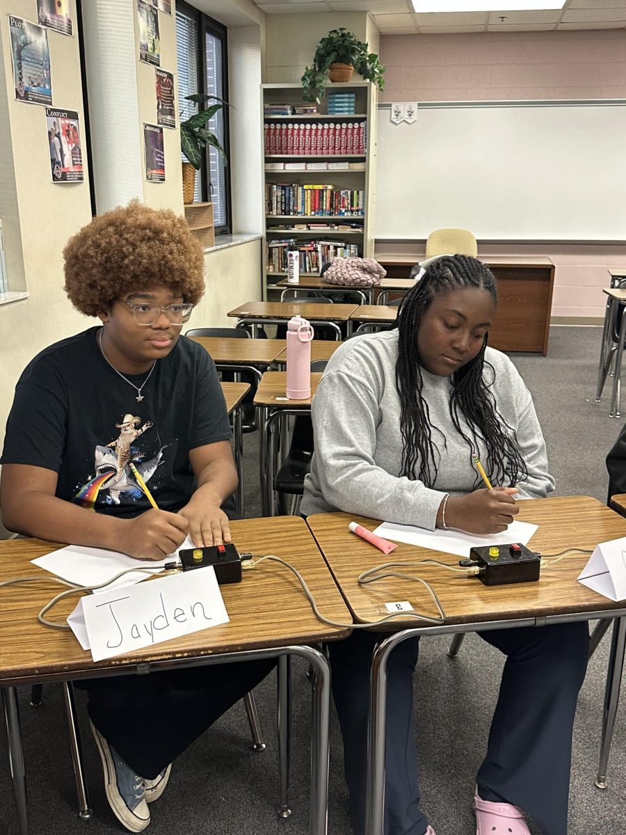 Jayden Valient listens to a question with Quiz Bowl teammate Chloe Smith during a recent competition.