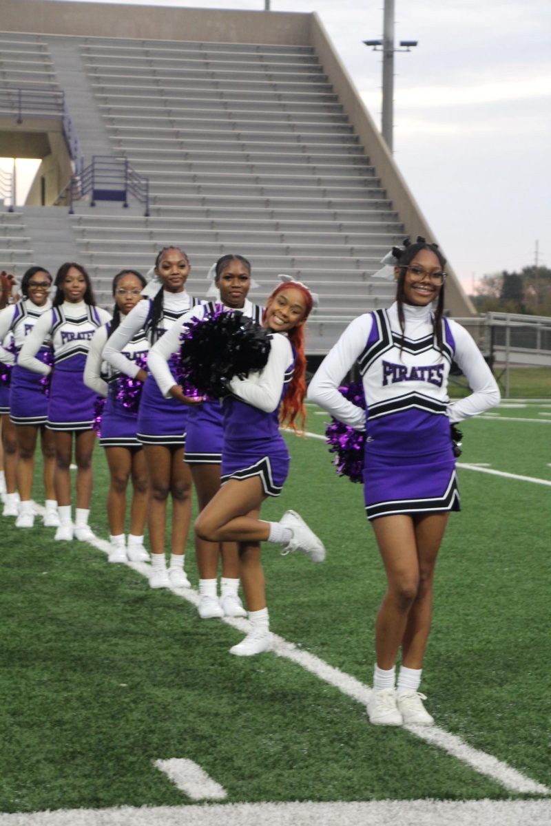 Senior Class President and Dance Captain Rosa Blevins poses in front of MHS' cheerleaders at the flyover event.