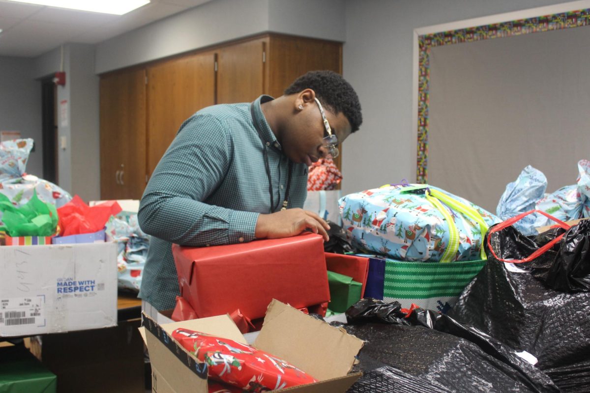 Lamonte Baker carefully wraps a gift for the annual wish list project run by Student Government. 