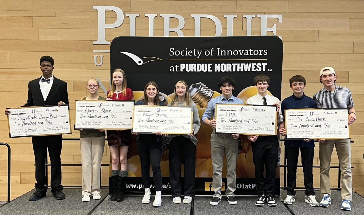 Isaiah Harvey (far left) receives a check from the Society of Innovators at Purdue Northwest.