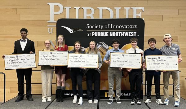 Isaiah Harvey (far left) receives a check from the Society of Innovators at Purdue Northwest.