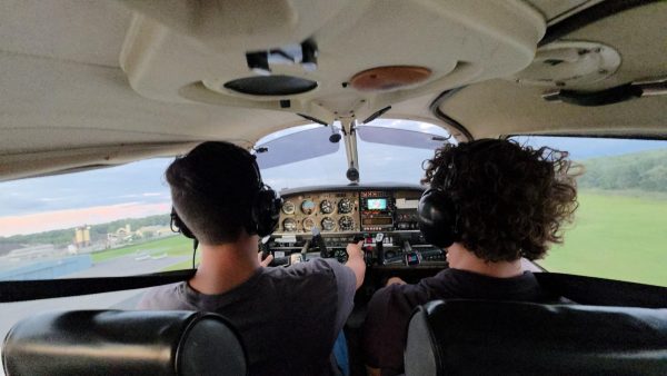 Junior Aydan Gabriel takes the wheel next to his flight instructor during a recent lesson.