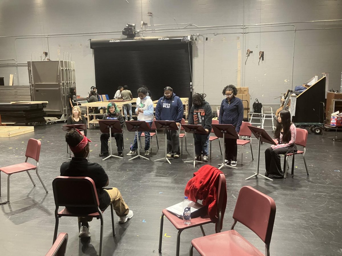 Members of the Thespian Troupe practice with Ms. Mia Godfrey for their performance of a series of staged readings on gun violence.