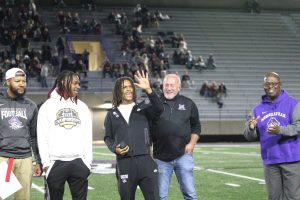 Demarco Easter, shown with Pole Vault Coach Gary Lindsey and fellow state champ Jaylen Ramsey, admires the ring he received for winning the State Championship.