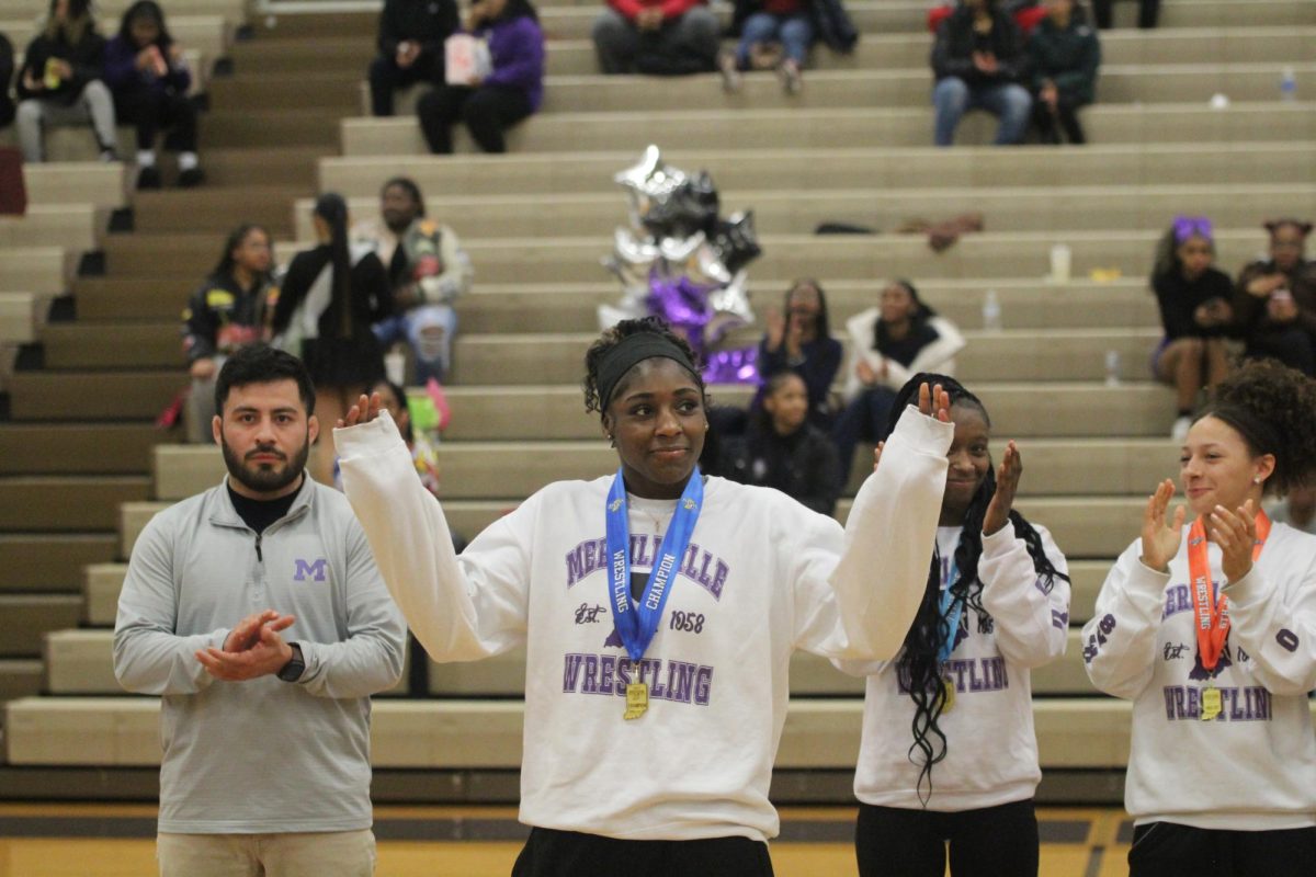 Izzy Lawrence is recognized at halftime of the boys basketball game after winning the State wrestling title.