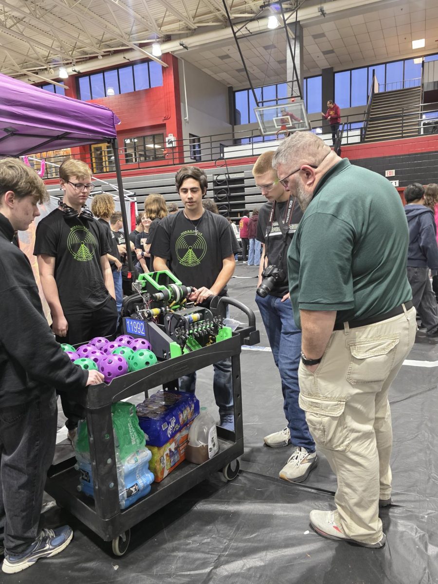Max Koehler, Jackson Moreland and Aydan Gabriel display their robot at the state competition. 