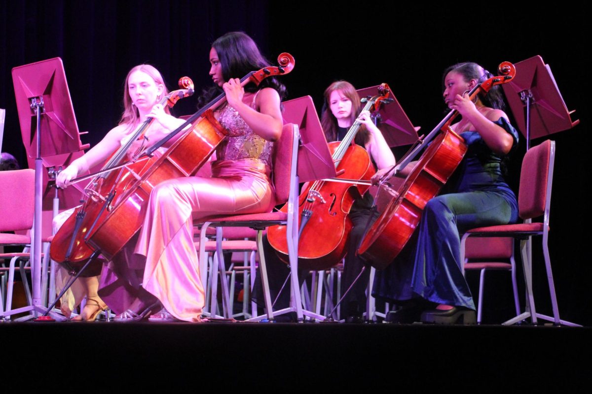 Senior cellists Rheana Early, Elise Cheatham, Hope Garrett and Kailyn Bryant perform at their final orchestra concert.